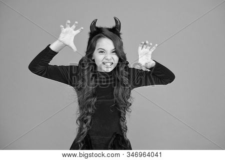 Halloween Costumes Designed After Supernatural Figures. Little Devil. Little Girl Red Horns Celebrat