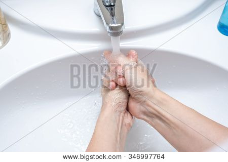 Woman Washing Hands Under The Faucet With Water, Hygiene And Profilactics Concept.