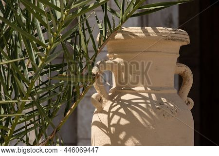 An Old Vase In Front Of The Building