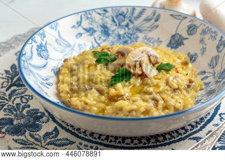 Parmesan Cheese Risotto With Mushrooms And Saffron, In A Beautiful Close-up Plate, Selective Focus. 