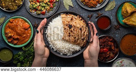 Assorted Indian Ethnic Food Buffet On Rustic Concrete Table From Above: Curry, Fried Samosa, Rice Bi