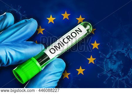 Eu Outbreak Of Omicron Variant. A Hand In A Blue Rubber Glove Holds A Test Tube With Covid-19 Virus 