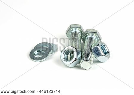 Several Metal Bolts With Washers And Nuts On A White Background. Close-up
