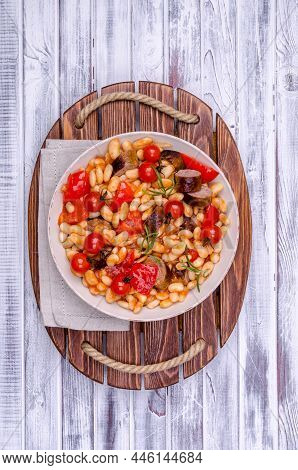 Braised Beans With Vegetables And Fried Sausages On A Wooden Background. Top View.