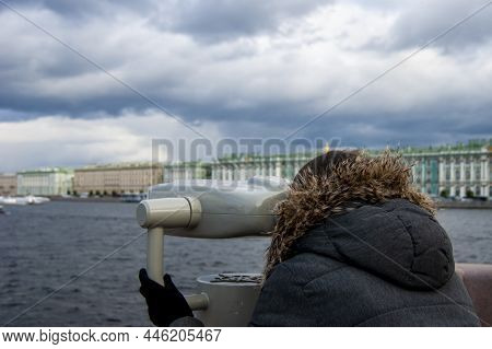 Girl Looks In Binoscope On City. Walk Around St. Petersburg