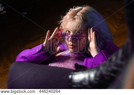 The Girl Is Like In The Clip From The 80S 90S. Short Blonde Haircut. The Girl Is Sitting On A Chair