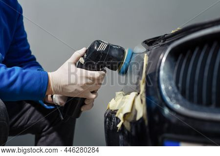 Car Headlights Cleaning With Power Buffer Machine At Car Service