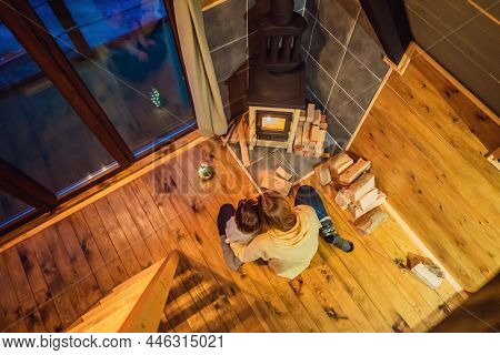 Mom And Son Spend Time By The Fireplace In Glamping. Rest In The Mountains In Glamping. Cozy Firepla