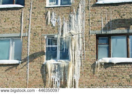 Iced Wall Of A Brick House, Emergency Situation. Severe Weather Conditions, Frosts In Winter.