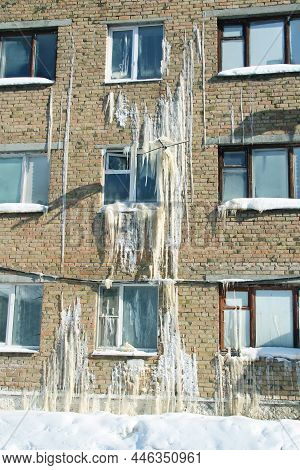 Iced Wall Of A Brick House, Emergency Situation. Severe Weather Conditions, Frosts In Winter.