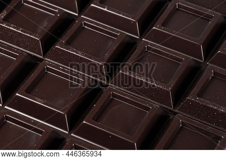 Close Up A Chocolate Bar Background. Chocolate Bar Cubes Macro.