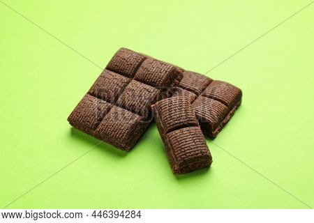 Pieces Of Delicious Hematogen On Green Background