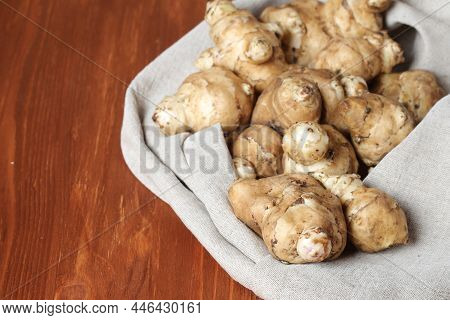 Raw Jerusalem Artichoke On A Gray Linen Cotton Napkin. Jerusalem Artichoke Solar Root, Earthen Pear.