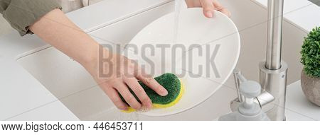 Woman Housewife Is Doing The Dishes At Home Kitchen.