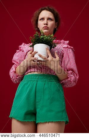 Beautiful Woman In Green Shorts Flowerpot Posing Close-up Unaltered