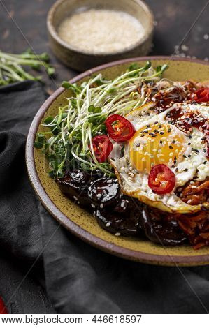 Traditional Korean Dish Bibimbap. Bowl With Rice, Shiitake Mushrooms, Chicken, Cucumber And Microgre