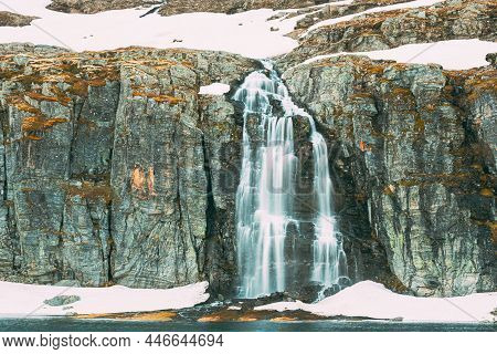 Road Aurlandsfjellet, Norway. Waterfall Flotvatnet In Spring Snowy Landscape. Scenic Route Road In S