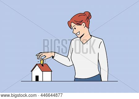 Saving Money For Buying Apartment Concept. Young Smiling Woman Standing And Putting Golden Coin To S