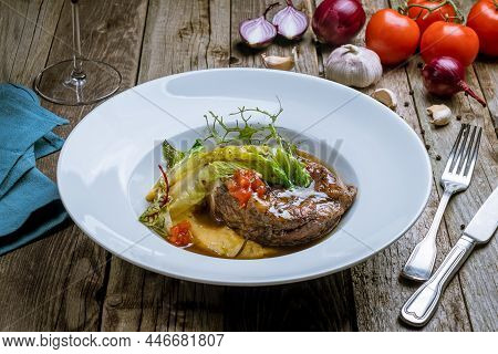Osso Buko On Plate On Old Wooden Table Side View