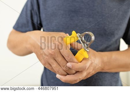 Hands Of Male Patient Is Doing Palm Or Wrist Exercise With Spring Hand Grip,squeeze With Hand Expand