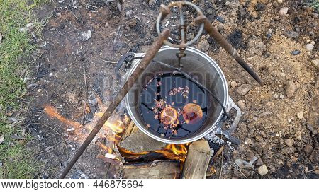 Mulled Wine In A Tourist Pot Over Hot Camp Fire. Mulled Wine By The Fire. Mulled Wine Cooked On Fire