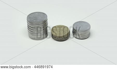 Pile Of Indian Rupee Coins. Two Rupee And Five Rupee And One Rupee Coins. On A White Background
