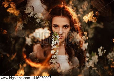 Portrait Of A Romantic Girl In A Blooming Garden With Elements Of Phantasmagoria. The Concept Of Fan