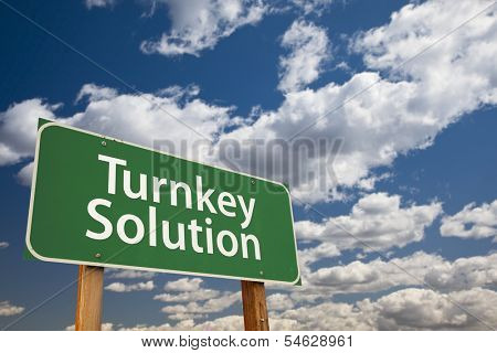 Turnkey Solution Green Road Sign with Dramatic Sky and Clouds.