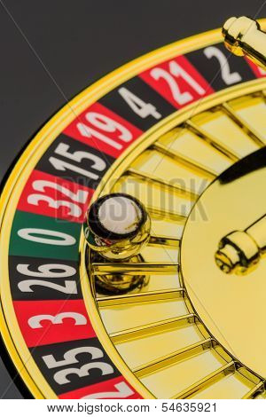 the cylinder of a roulette gambling in a casino. winning or losing is decided by chance. number zero, lost everything
