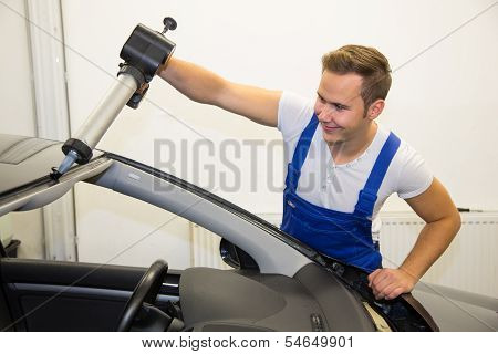 Glazier With Application Gun Applying Adhesive For Windshield Replacement