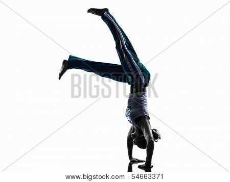 one caucasian woman capoiera dancer dancing in silhouette studio isolated on white background