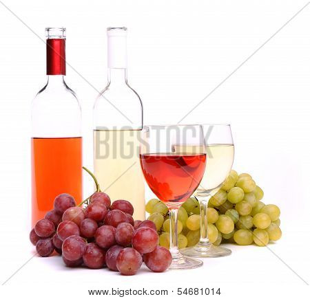 Glasses, bottles of wine and grapes
