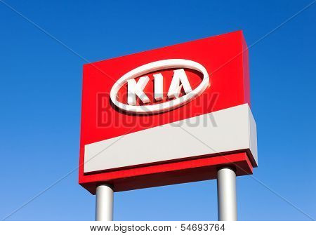 Samara, Russia - November 23: The Emblem Kia Motors On Blue Sky Background, November 23, 2013 In Sam