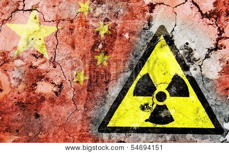 Old Cracked Wall With Radiation Warning Sign And Painted Flag