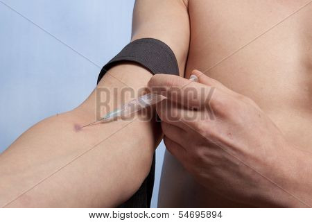 Drug addict man with syringe in action