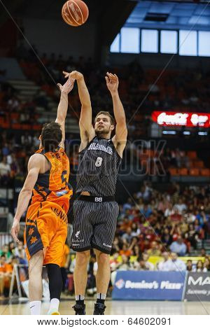 VALENCIA - MAY, 3: Outside shooting of Bertans #8 during a Spanish league match between Valencia Basket Club and Bilbao at the Fonteta Stadium on May 3, 2014 in Valencia, Spain