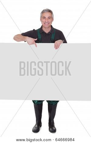 Mature Male Gardner Holding Placard