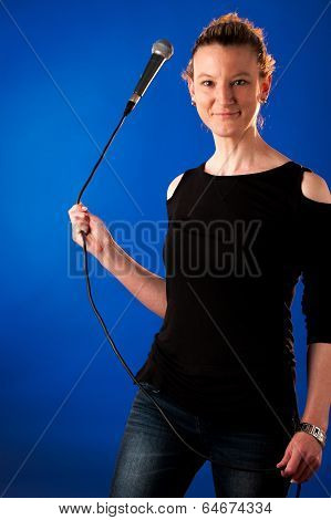 Woman Singer On Bluue Background With Microphone