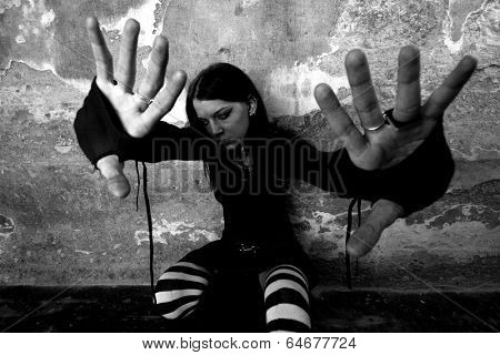 Beautiful serious girl by the wall