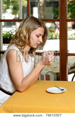 Girl In Cafe Drinking Coffee