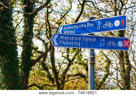 Closeup on tourist Sign posts in village of Ravenscar UK.