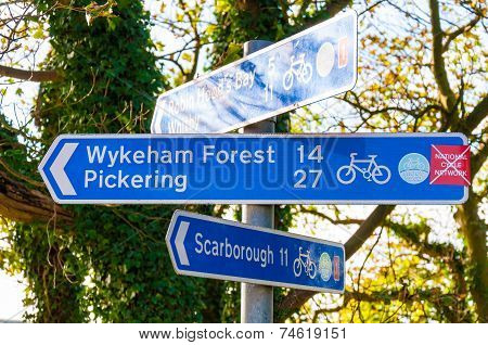 Closeup on tourist Sign posts in village of Ravenscar UK.
