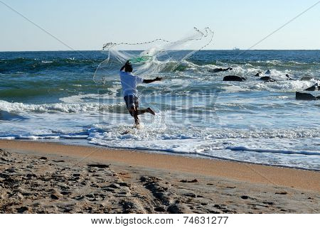 Man Throwing Casting Net