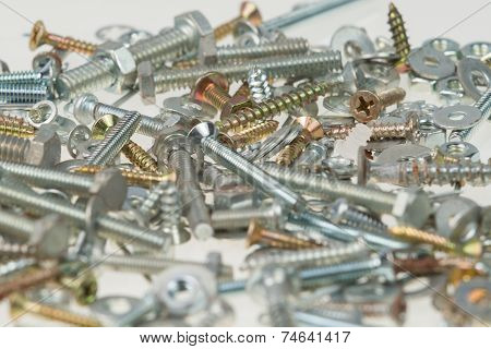 Screws, Nuts, And Bolts On Isolated White Background