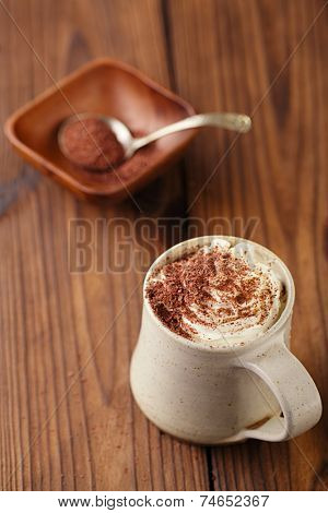 hot chocolat vintage mug, topping with cream and grated chocolate, shallow dof