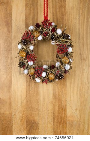 Decorated Christmas Wreath Walnuts And Pine Cones On Sapele Wood Background