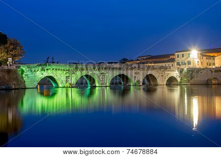 Twilight On Cityscape. Rimini, Historical Tiberius Bridge.