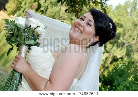 Young brunette overweight bride posing for the camera