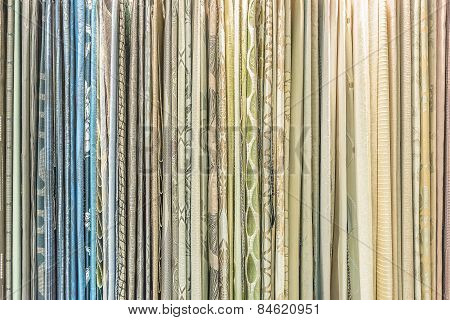 Colorful Curtain Samples Hanging From Hangers On A Rail In A Display In A Retail Store