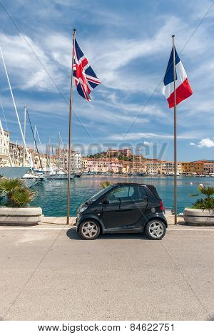 small car on the waterfront of Porto Azzurro, Italy
